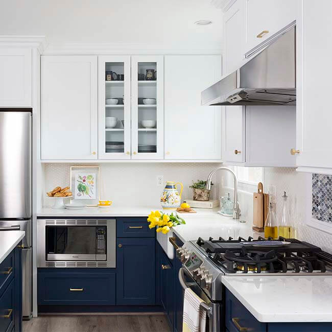Navy and white kitchen remodel, stainless steel appliences, white quartz counters, pendant lights - Halifax Case Design