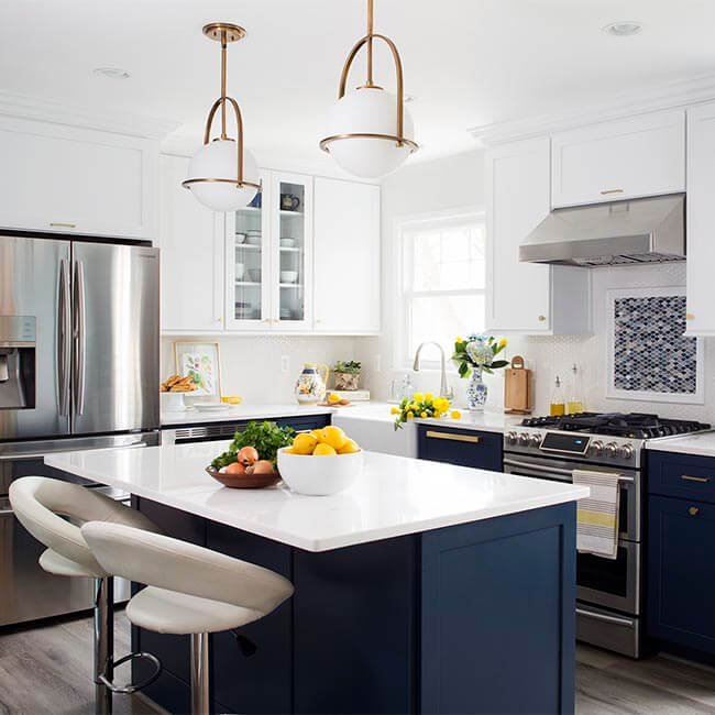Navy and white kitchen remodel, stainless steel appliences, white quartz counters, pendant lights - Halifax Case Design