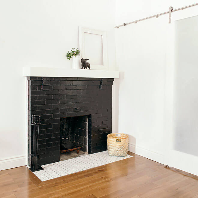 refurbished fireplace, hearth tile, and hardwood flooring with sliding barn door to kitchen Case Halifax