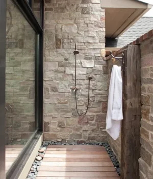 outdoor stone shower Designed by John Kraemer & Sons contractor